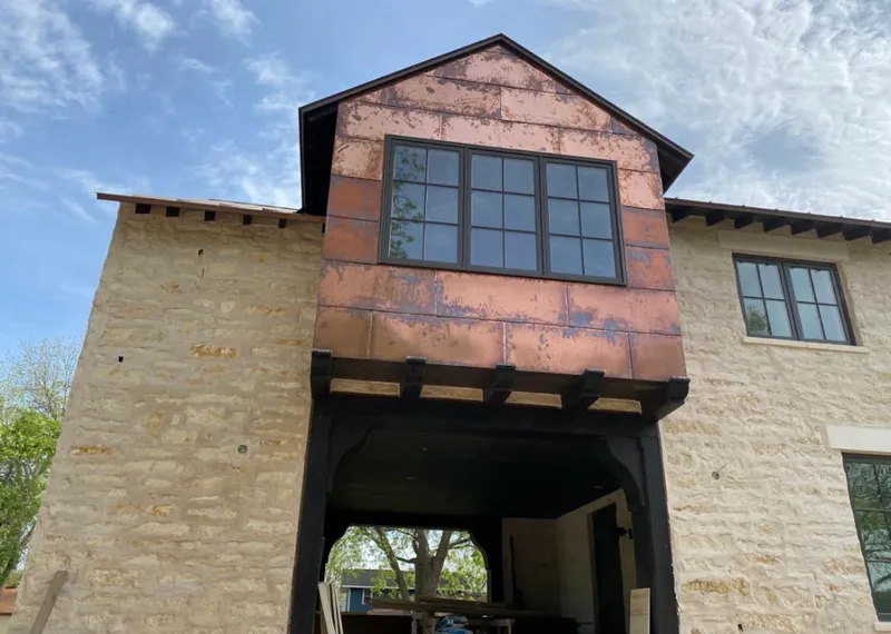 Copper metal panel facade on a stone building for Roof Repair in Roanoke